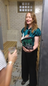 photo of AA Abbott reading her book in cell